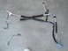 2003 Ford Taurus - AC hoses removed from a vehicle, laid out on concrete.