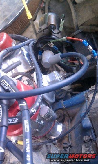 Close-up of engine distributor cap, spark plug wires, and related components