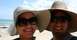 1987 Ford Bronco - A couple enjoys a day at the beach, posing for a selfie under a bright blue sky.