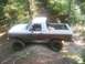 1989 Ford Bronco - This lifted 1989 Ford Bronco navigates a muddy trail during an off-road event.