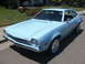 1972 Ford Pinto - A light blue 1972 Ford Pinto is parked on a street in front of a house.