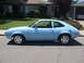 1972 Ford Pinto - A light blue 1972 Ford Pinto coupe is parked on the side of a street in front of a house.