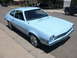 1972 Ford Pinto - A light blue 1972 Ford Pinto coupe is parked on a street in a residential neighborhood.