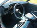 1972 Ford Pinto - The interior of a 1972 Ford Pinto shows blue vinyl seats and a dashboard with a blue steering wheel cover.
