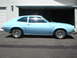 1972 Ford Pinto - A light blue 1972 Ford Pinto coupe is shown from the side, parked in front of a garage door.