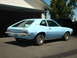 1972 Ford Pinto - A light blue 1972 Ford Pinto hatchback is seen from the rear quarter angle in front of a residential garage.
