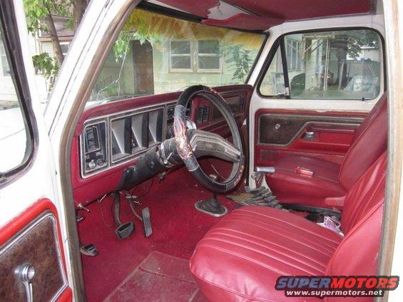 1978 Ford Bronco interior with red seats, dashboard, and steering wheel
