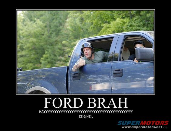 Man in blue pickup truck wearing a helmet gives a thumbs up