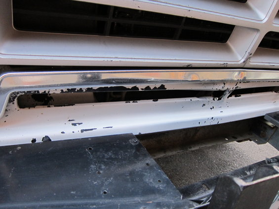 1987 Dodge 1500 front grille with chrome trim and white painted bumper showing paint chips