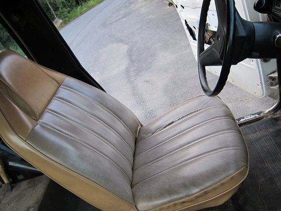 Torn driver's seat and steering wheel inside a vehicle