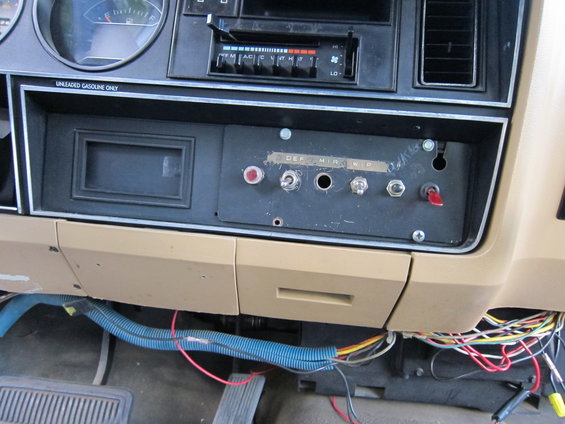 Dashboard with aftermarket switches labeled DEF, MIR, and WP. Some wiring is visible