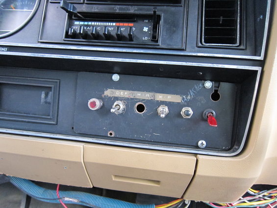 Dashboard interior with DEF, MIR, WIP switches and a red toggle switch