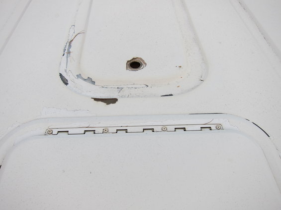 White panel with recessed areas and hinge