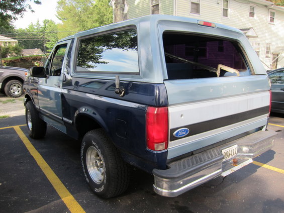 Ford Bronco parked in a lot, rear view. License plate reads 88841J
