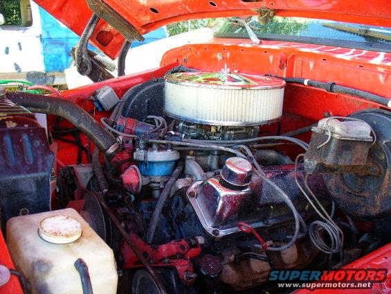 Engine bay with V8 engine, chrome air cleaner, and red paint