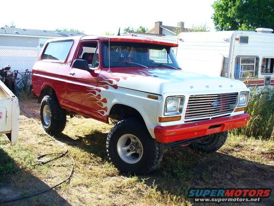 Red and white 1979 Ford Bronco with flame decals, 3/4 front view