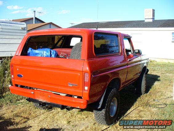 Red 1979 Ford Bronco rear view with spare tire in cargo area