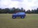 1992 Ford Bronco - This lifted 1992 Ford Bronco sits in a field under a cloudy sky.