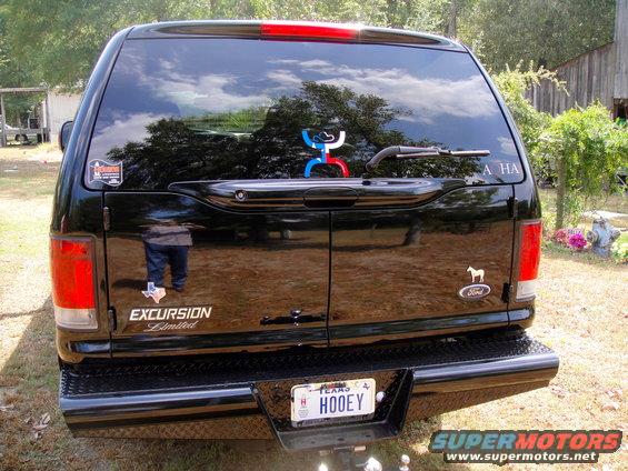 Rear view of a black 2005 Ford Excursion Limited with a Texas license plate that reads HOOEY
