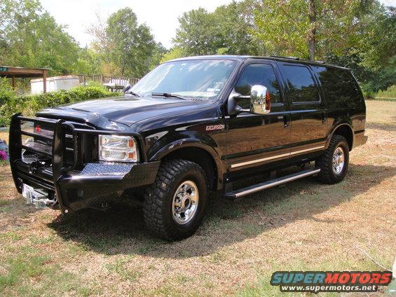 2005 Ford Excursion SUV, black, with aftermarket brush guard and side steps, parked outdoors
