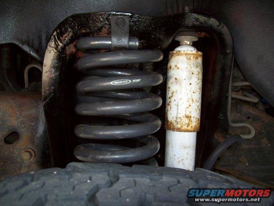 Front suspension coil with 'DEAVER H50R' text and rusty shock absorber