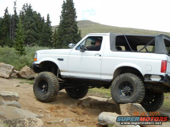 White 1996 Ford Bronco with soft top on rocky terrain