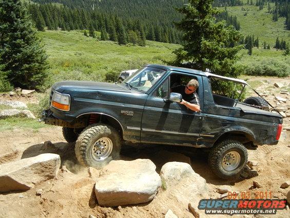 Dark green 1996 Ford Bronco navigating rocky terrain