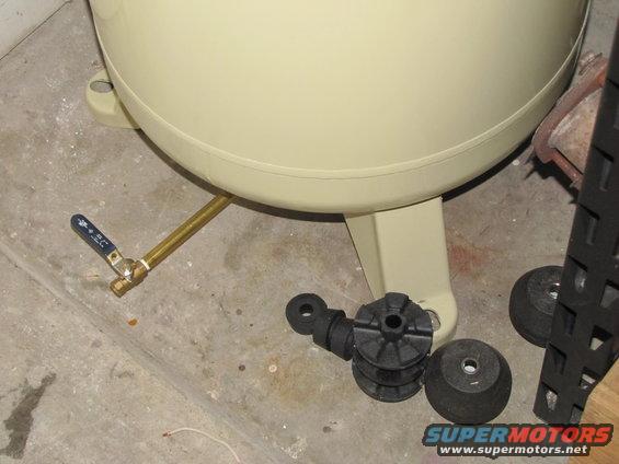Air compressor tank drain valve and rubber mounts on concrete floor