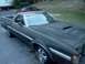 1979 Ford Ranchero - This 1979 Ford Ranchero features a brown vinyl top and a hood scoop, seen from a three-quarter front angle.
