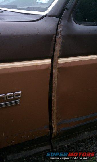 Original drivers side door has crimp and rust.