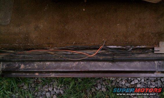 No threshold molding on the drivers side, showing old speaker wires.