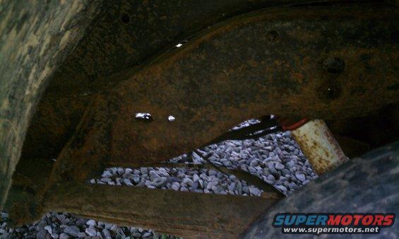 Rear drivers side frame, original paint is still visible.