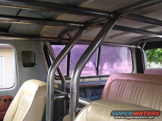 Interior view of a 1979 Ford Bronco with a custom roll cage installed over the seats and headliner
