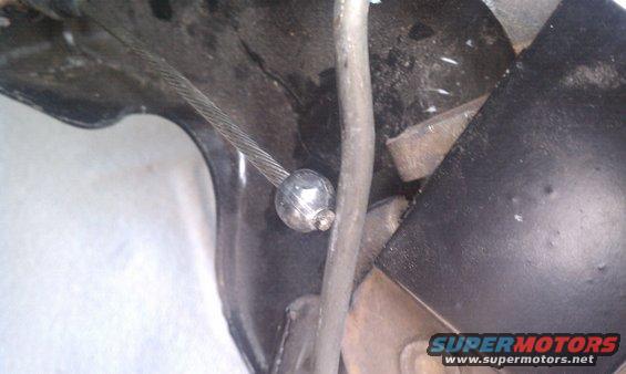 Close-up of parking brake cable mechanism with metal ball end