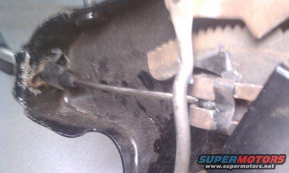 Close-up of parking brake mechanism with cable and ratchet
