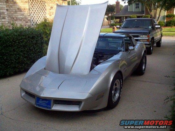 Silver 1982 Chevrolet Corvette with hood open, showing engine bay