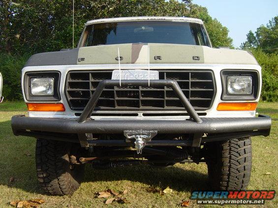 Front view of a 1979 Ford F-Series truck with a custom bumper and camouflage hood