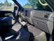 2004 Ford F-250 - The interior of a 2004 Ford F-250 pickup truck is shown from the passenger side, with a view of the dashboard and seats.
