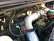 2004 Ford F-250 - Close-up view of an engine bay, highlighting the turbocharger and associated plumbing, with an 'ENGINE OIL' cap visible.