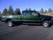 2004 Ford F-250 - Side view of a green 2004 Ford F-250 crew cab pickup truck parked outdoors.