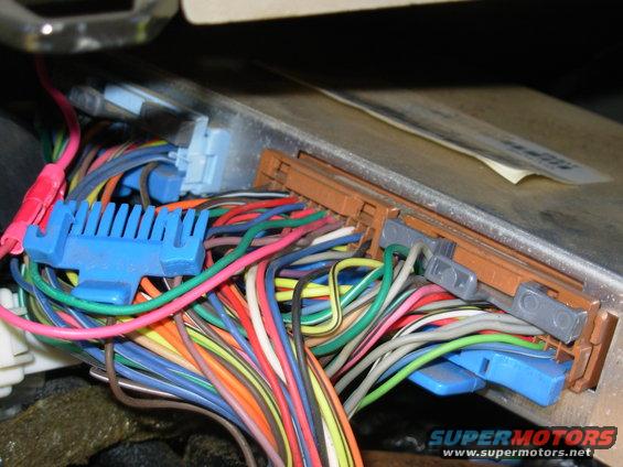 idle8.jpg I simply pushed the new pigtail terminals into the connector - I never removed the connector from the PCM, or the PCM from the dash.  The far terminal (B7, my DG wire) is for 1360 RPM; the near (B8, my Pk wire) is for 1170 RPM.  Grounding both produces a 1600 RPM idle.