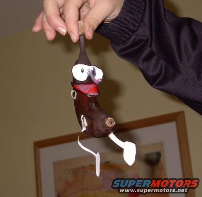 Handmade banana doll with a face held by a hand
