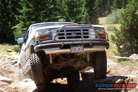 1996 Ford Bronco front grille and brush guard, driving off-road over rocks