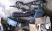 1992 Ford Bronco - Engine air intake components and a wiring harness are laid out on a concrete surface, possibly for repair or replacement.