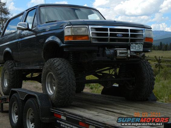 Dark blue 1996 Ford Bronco with winch on trailer