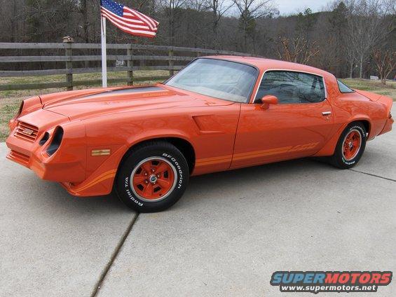 Orange 1979 Chevrolet Camaro with racing stripes and red wheels
