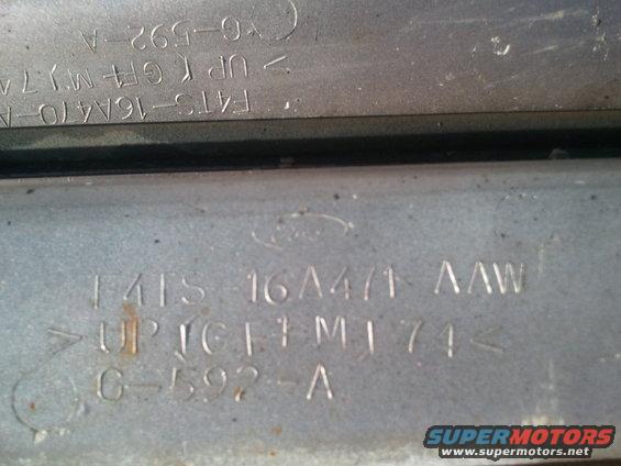 Metal plate with stamped Ford logo and part numbers