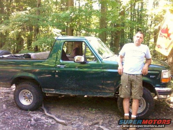 Green 1993 Ford Bronco parked in woods