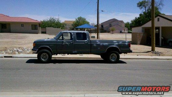 Gray Ford F-250 Super Duty crew cab pickup truck parked on street