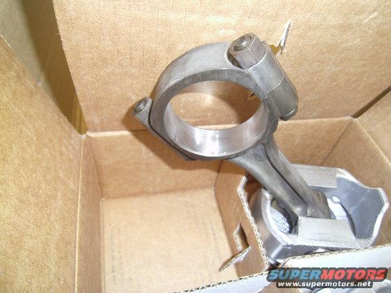 Engine connecting rod and piston assembly in cardboard box